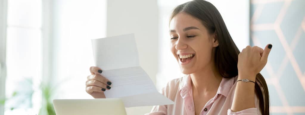 Happy young woman excited by reading good news in letter